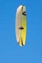 The wing of paraplan against a blue sky. Bottom view. Two paragliderists are flying in tandem.