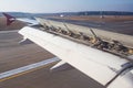 The wing of a passenger aircraft with air brakes and mechanization under them at the flaps after landing