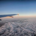 Wing of the plane over the clouds Royalty Free Stock Photo