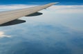 Wing of plane over mountain. Airplane flying on blue sky and white clouds. Scenic view from airplane window. Commercial airline Royalty Free Stock Photo