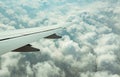 Wing of plane over white clouds. Airplane flying on blue sky. Scenic view from airplane window. Commercial airline flight. Plane Royalty Free Stock Photo