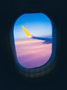 The wing of the plane and the sky, purple clouds, the view from the window of the plane during the flight Royalty Free Stock Photo