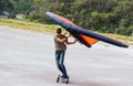 Wing Surfer, man on skateboard flying a wing, foil wing, sky wing, riding the wind with a wing on a skateboard Royalty Free Stock Photo