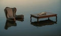 Wingback chair and table with doll floating on water surface Royalty Free Stock Photo