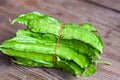 Winged Bean on wooden background, Psophocarpus tetragonolobus - Green winged or Four angle beans