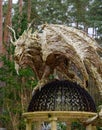 Winged Dragon made of wood. Art sculpture at