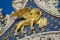 Winged golden lion decorating upper facade of the Saint Mark`s Basilica in Venice, Italy.
