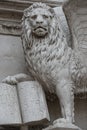 Winged lion with a Bible and a priest at Basilica San Marco in Venice, Italy, summer time, details, closeup Royalty Free Stock Photo