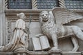 Winged lion with a Bible and a priest at Basilica San Marco in Venice, Italy, summer time, details, closeup Royalty Free Stock Photo