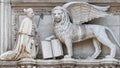 Winged lion with a Bible and a priest at Basilica San Marco in Venice, Italy, summer time, details, closeup Royalty Free Stock Photo