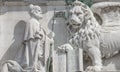 Winged lion with a Bible and a priest at Basilica San Marco in Venice, Italy, summer time, details, closeup Royalty Free Stock Photo