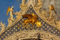 Winged lion sculpture symbol of Venice on St. Mark`s basilica facade in center of Venice, Italy translation Royalty Free Stock Photo