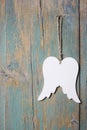 Wings of angel hanging on wooden background