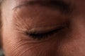 wink female eye with wrinkles around