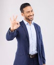 Wink, portrait and asian man with perfect hand sign for support, agreement or feedback, thank you or review on grey