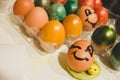 Winking easter egg between other collored eggs. Easter celebration and egg hunt concept