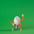 Winking Easter egg toy on a green Royalty Free Stock Photo