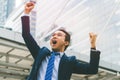 Winner businessman raising arm up to the sky and shouting celebrate success in the city Royalty Free Stock Photo