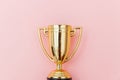 Winner or champion gold trophy cup isolated on pink pastel colorful background Royalty Free Stock Photo