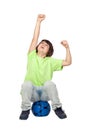 Winner child sitting on blue soccer ball Royalty Free Stock Photo