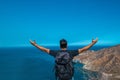 Winner / Concept of success. Hiking man cheering euphorically and happily with his arms raised in the sky after walking to the top Royalty Free Stock Photo