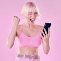 Winner, fashion and woman with phone on pink background for success, winning and online competition. Smartphone, beauty