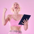 Winner, fashion and woman with tablet on pink background celebrate success, winning and online competition. Digital tech