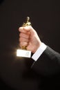 Oscar award in hand