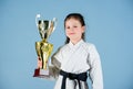 Winner little girl in gi sportswear. practicing Kung Fu. happy childhood. sport success in single combat. girl with