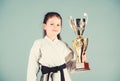 Winner little girl in gi sportswear. practicing Kung Fu. happy childhood. sport success in single combat. girl with