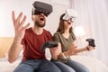 Funny vigorous couple gaming in VR glasses