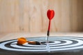 Winner Red dart arrow hit the center target of dartboard and yellow arrow loser metaphor marketing competition concept Royalty Free Stock Photo