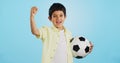 Winner, soccer ball or face of child in studio with smile, joy or happiness for sports success, score or goal. Happy boy