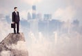 Winner urban businessman on top of stone Royalty Free Stock Photo