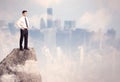 Winner urban businessman on top of stone Royalty Free Stock Photo