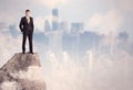 Winner urban businessman on top of stone Royalty Free Stock Photo