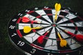 Winner yellow dart arrow hit center target of dartboard and other arrow loser metaphor marketing competition concept, on dark Royalty Free Stock Photo