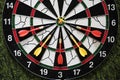 Winner yellow dart arrow hit center target of dartboard and other arrow loser metaphor marketing competition concept, on dark Royalty Free Stock Photo