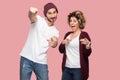 Winner is you! Portrait of funny suprised couple of friends in casual style standing and pointing figrer to you, looking at camera Royalty Free Stock Photo