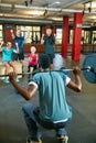 Winners are people who never quit. a man lifting weights while a group of people in the background watch on. Royalty Free Stock Photo