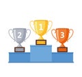 Winners podium with gold, silver and bronze cups - stock Royalty Free Stock Photo