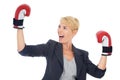 Winning the business fight. A young woman looking excited while wearing boxing gloves. Royalty Free Stock Photo