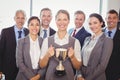 Winning business team with an executive holding trophy Royalty Free Stock Photo