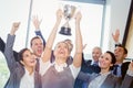 Winning business team with an executive holding trophy Royalty Free Stock Photo