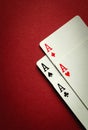 A winning combination of four aces in playing cards or four of a kind or quads. Concept of luck in the game of poker on a red Royalty Free Stock Photo