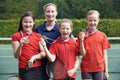 Portrait Of Winning Female School Tennis Team With Medals