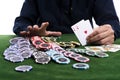 The winning gambler hand grabbing a pile of chips