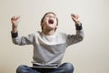 Winning a game. Happy boy screeming euphoric sitting with digital tablet computer. Royalty Free Stock Photo