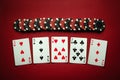 Winning at the poker club. Combination of full house or full boat playing cards and chips on a red table. Winning at a casino Royalty Free Stock Photo