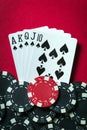 A winning poker combination is Royal Flush. Chips and cards on the red table in the poker club. Luck or Fortune Royalty Free Stock Photo